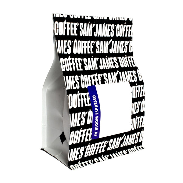 Sam James Coffee In Bloom espresso bag with allover, black and white logo print.